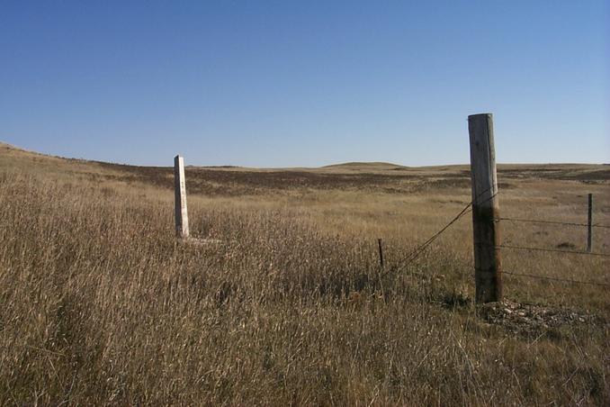 Tri-corner monument.  The pole marks the northeast corner of Montana.