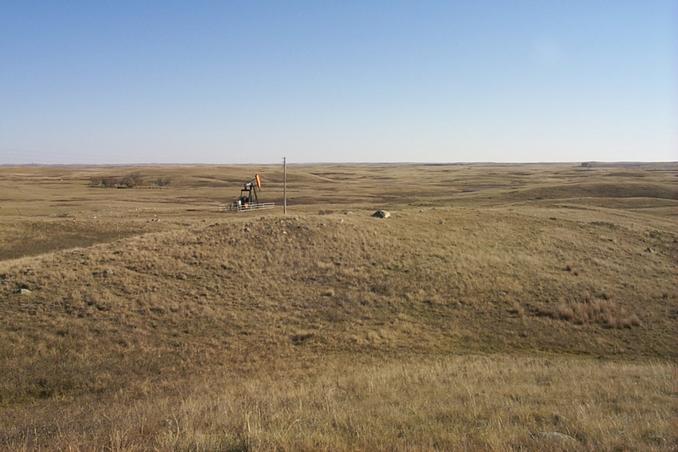 Overview of tri-corner (in center beyond the rock).  Saskatchewan in foreground, North Dakota on left beyond trees, Montana on distant right.