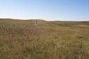 #4: The view southwest from the confluence showing the border marker 24 meters away.