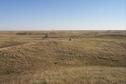 #9: Overview of tri-corner (in center beyond the rock).  Saskatchewan in foreground, North Dakota on left beyond trees, Montana on distant right.