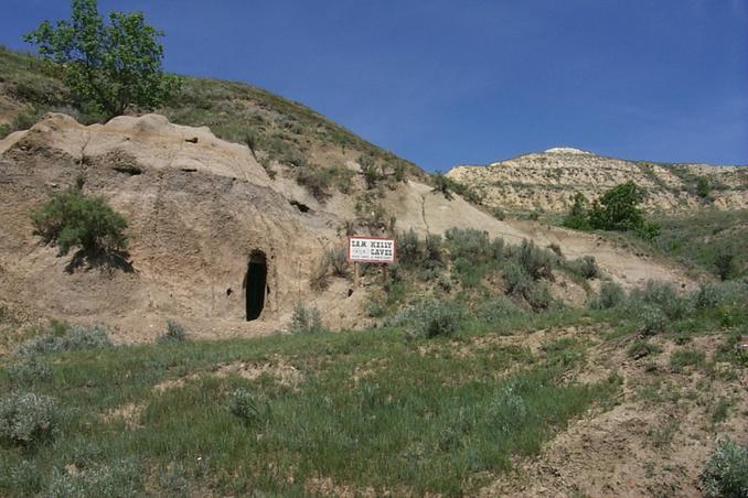 Outlaw cave about 340 m from CP.  The sign reads: "Sam Kelly Caves.  House Caves and Horse Caves".