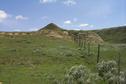 #6: The view east along the border.  Canadian flag flies on top of Peak Butte.