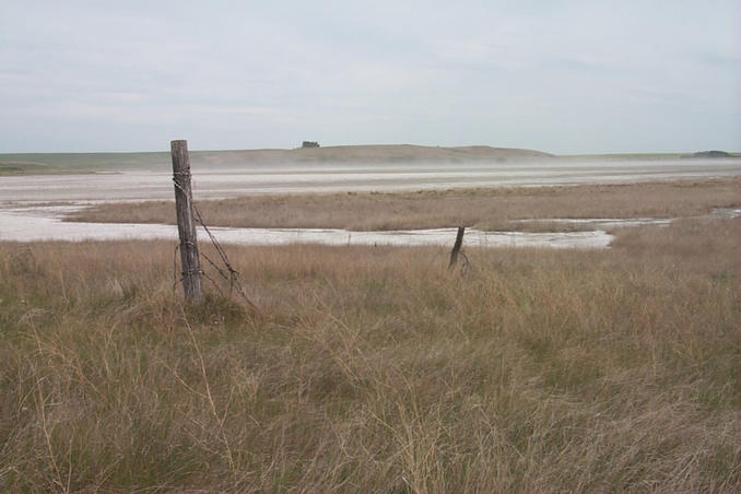 If you look closely you can see clouds of salts blowing across the dried lake bed.