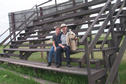 #5: Carolyn, Alan and Max on the bleachers on the Vanscoy rodeo grounds.