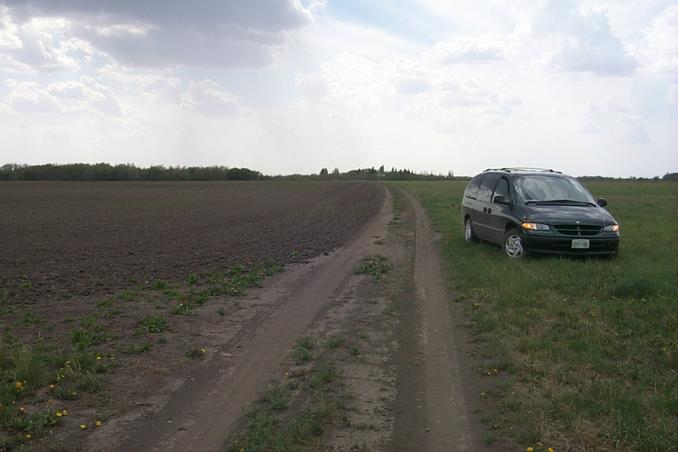 The view west along the dirt short cut between farms.