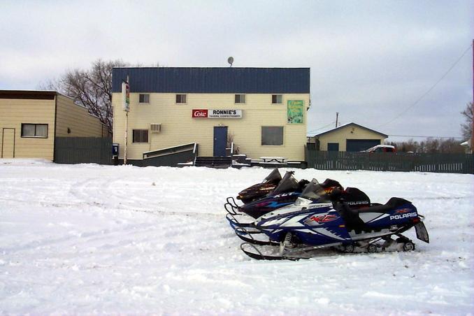 Snowmobiles parked at Ronnie's Tavern and Confectionery in Macdowell.