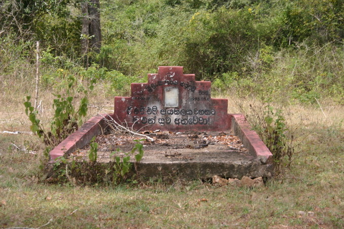 Tombstone with Sinhalese inscription by the path to the point
