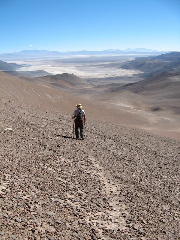 Sharky walking on Guanaco trail back to camp.  View of Salar Pedernales.