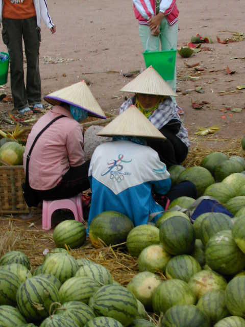 Watermelons and conical hats at the market on the way to the confluence