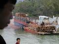 #8: Log barge off loading onto a cargo truck
