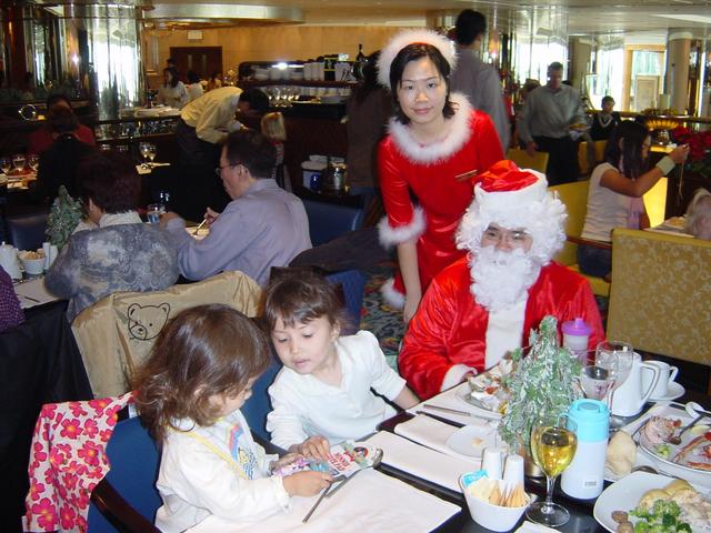 Father Christmas and his pretty helper visit the children.