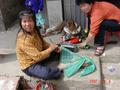 #10: Womenfolk sitting outside their homes weaving nets