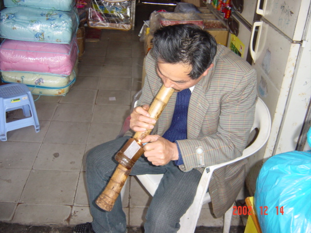 Practitioner demonstrates the art of smoking a bamboo bong.