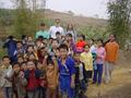 #6: Facing north from the confluence; left to right: Richard, Tony and Targ, with the children in front