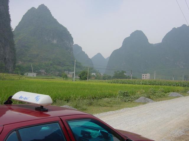 Confluence is in a cultivated valley nestled between tall karst mountains, 1.4 kilometres southwest of the road