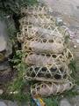 #10: Neatly stacked pile of piglets ready for market, each in its own handy bamboo carrying case