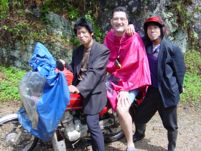 Two motorcyclists who took us to Xiao'aiping, and Tony kitted out in his brand new bright pink raincoat