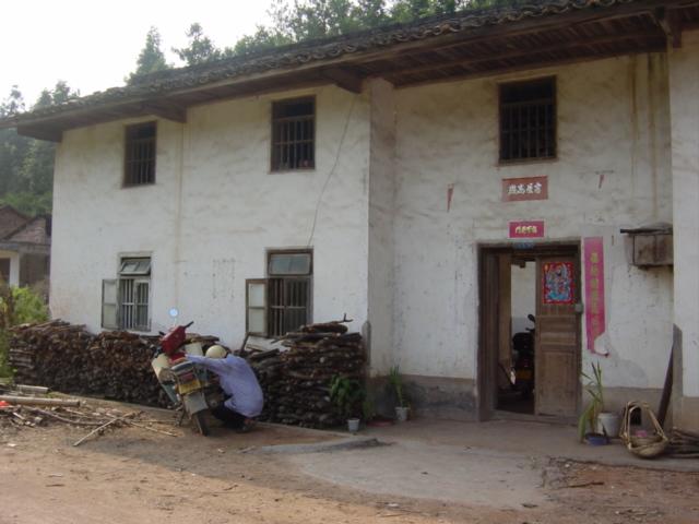 House where we left bike and bag, with motorcyclist double-checking bike