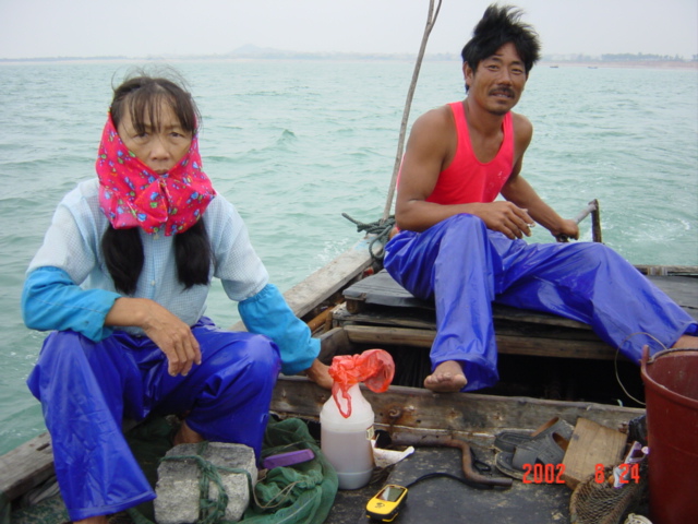 Local couple on their boat, motoring out to the confluence.