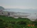 #2: Bluff overlooking the bay, with the confluence in the water just beyond the small rocky peninsular jutting out above the temple.