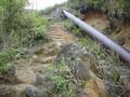 #6: Pipe channelling water to the power plant below, with steep path running up beside it