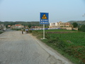 #2: View of the school looking back down the road towards Qiánxī, with the confluence 420 metres SE, off to the right.