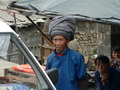 #2: Woman in minority nationality costume, with large headgear.