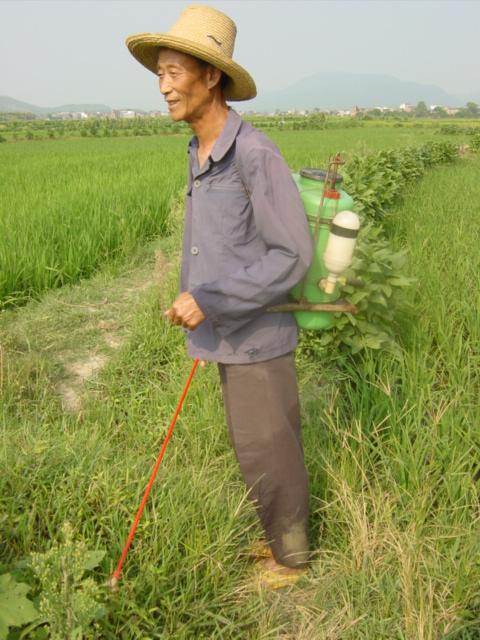 Peasant with backpack of poison spray