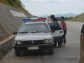 #2: Bus driver (left front) and ticket seller (right) in discussions with police regarding overloading