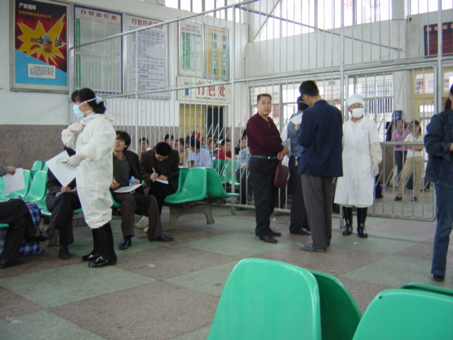 Temperature-taking and form-filling upon arrival at the Pingkou Railway Station--part of the nationwide effort to curb the spread of SARS