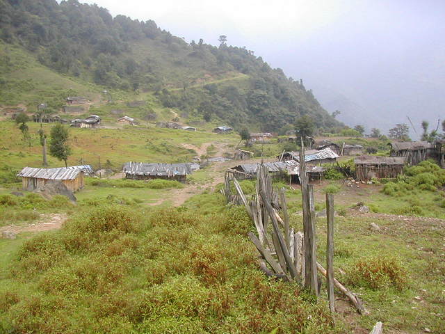 Village at the end of the plateau; the path behind winding up into the mountains towards the confluence.