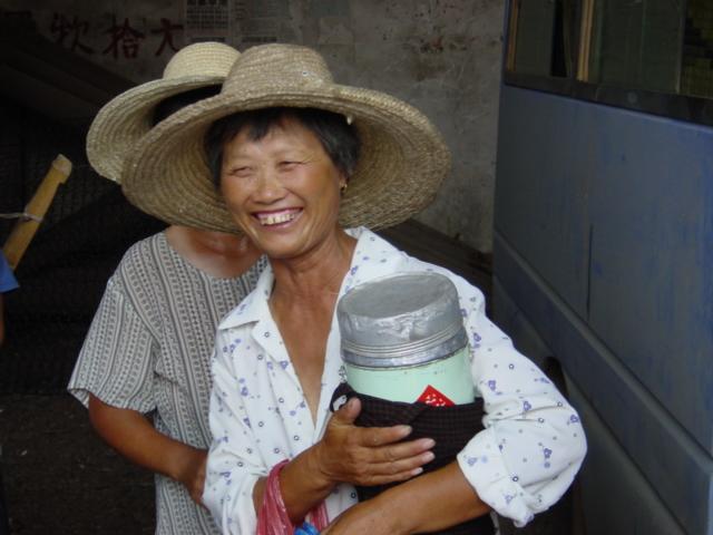 Ladies selling popsicles from giant thermos flasks at Leping bus station