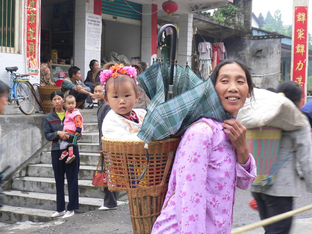 Cute little girl in a wicker backpack.