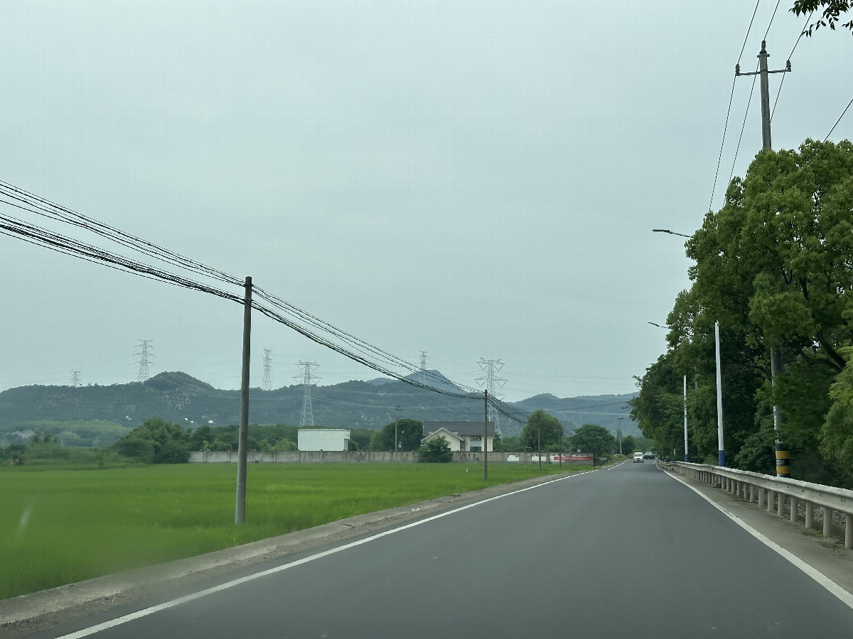 The peaceful countryside and the newly paved asphalt road.