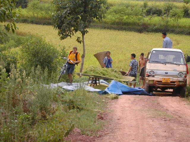 Rainer crossing the rice harvesters parked in the middle of the road