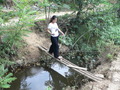 #6: Ah Feng crossing the stream on a tiny bridge