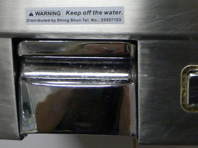 Sign on warm-air hand-dryer in China (HK) Ferry Terminal.