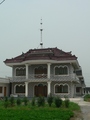 #4: The famous Oriental Pearl Tower atop a local house