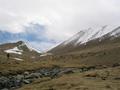 #5: Before U-shaped valley; 'confluence mountain' to right, front; Robert in front of intrusive dyke to left.