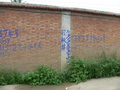 #5: Looking east (from 38 m west of the confluence), directly at the tall perimeter wall