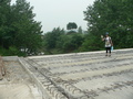 #5: Ah Feng crossing the canal on the foundations of the new road bridge