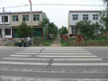 #2: Ah Feng at the pedestrian crossing 460 m south of the confluence, which marks the beginning of a small dirt road, nestled between two houses
