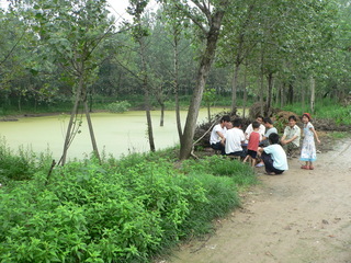 #1: Locals playing mahjong next to the confluence pond