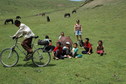 #8: The waiting party and the Yak herders with one of them trying out the mountain bike
