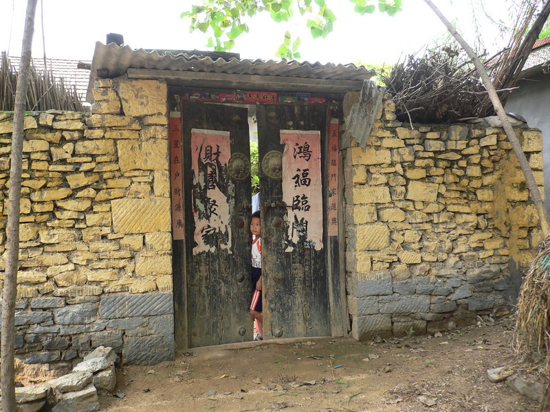 Wall made from stone, with an old wooden door