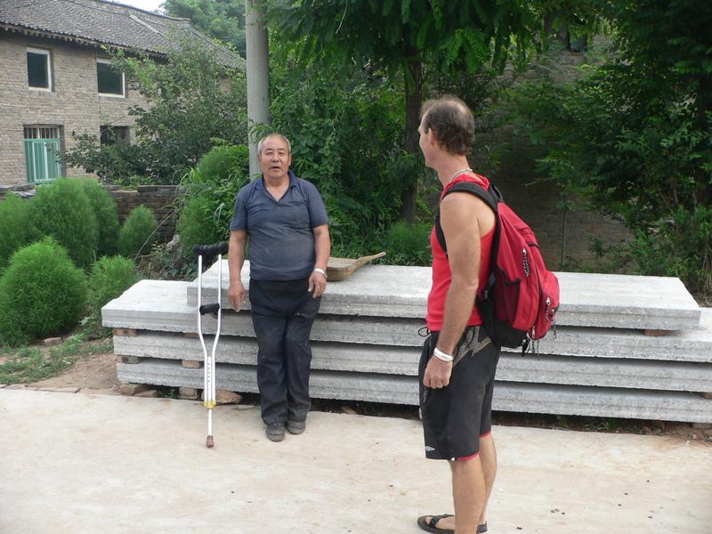 Peter chats with a friendly local in Huanghou Village