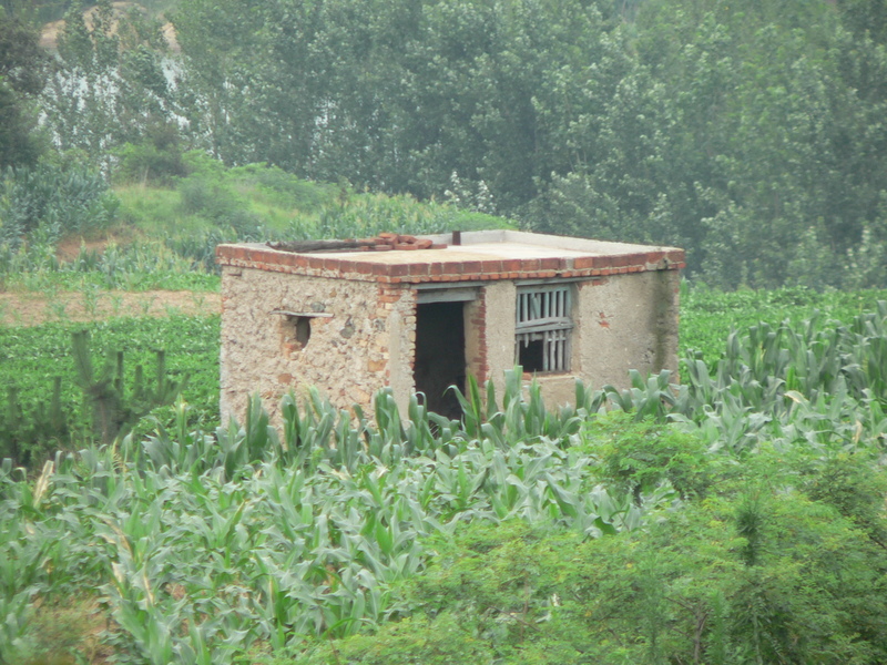 Small stone and brick shed north the confluence