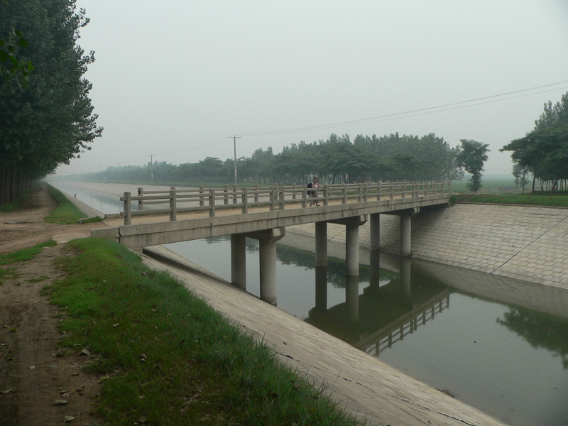 Ah Feng crossing a canal, 1 km from the confluence