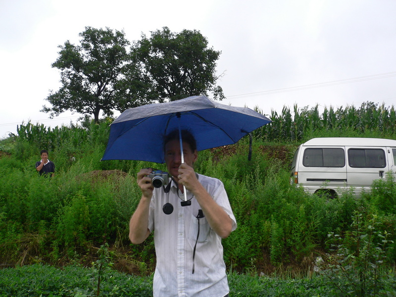 Targ taking the confluence photos, with the minivan and driver on the road behind