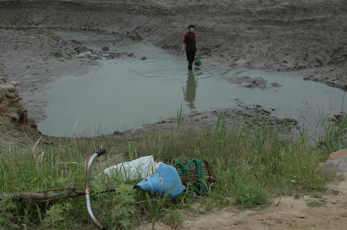 A lady digging clam within meters from the Confleunce Point